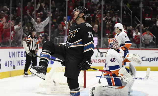 Washington Capitals center Nic Dowd (26) celebrates his goal against New York Islanders goaltender Semyon Varlamov (40) during the first period of an NHL hockey game, Friday, Nov. 29, 2024, in Washington. (AP Photo/Nick Wass)