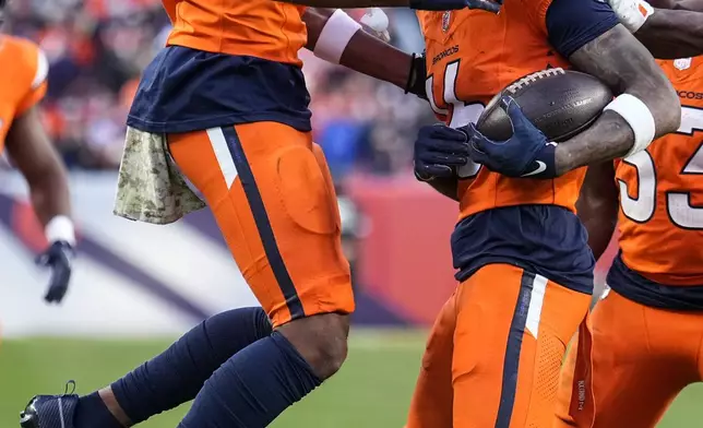 Denver Broncos wide receiver Troy Franklin, right, celebrates his touchdown with wide receiver Devaughn Vele (17) during the second half of an NFL football game against the Atlanta Falcons, Sunday, Nov. 17, 2024, in Denver. (AP Photo/Jack Dempsey)