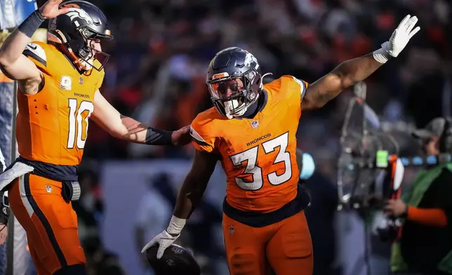 Denver Broncos running back Javonte Williams (33) celebrates his touchdown with quarterback Bo Nix (10) during the first half of an NFL football game against the Atlanta Falcons, Sunday, Nov. 17, 2024, in Denver. (AP Photo/Jack Dempsey)