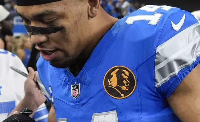 Detroit Lions wide receiver Amon-Ra St. Brown (14) wears a John Madden patch on his jersey for an NFL football game against the Chicago Bears, Sunday, Nov. 17, 2024, in Detroit. (AP Photo/Carlos Osorio)