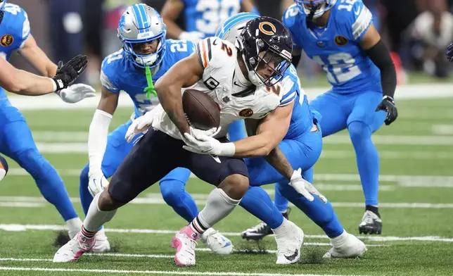 Chicago Bears wide receiver DJ Moore (2) runs for yardage after a catch against the Detroit Lions during the first half of an NFL football game, Sunday, Nov. 17, 2024, in Detroit. (AP Photo/Carlos Osorio)