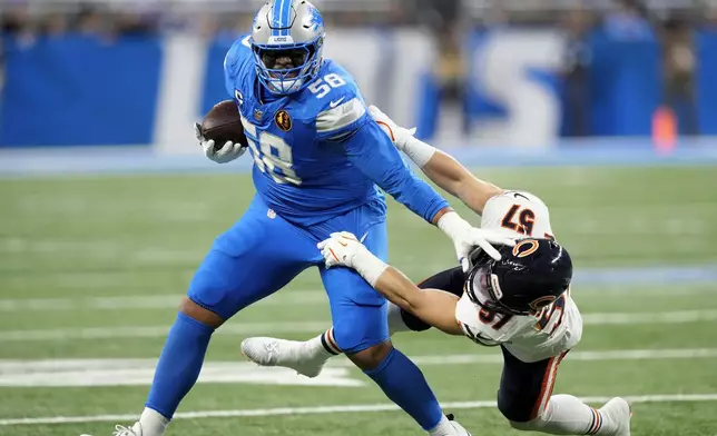 Detroit Lions offensive tackle Penei Sewell (58) sheds the tackle of Chicago Bears linebacker Jack Sanborn (57) during the first half of an NFL football game, Sunday, Nov. 17, 2024, in Detroit. (AP Photo/Carlos Osorio)