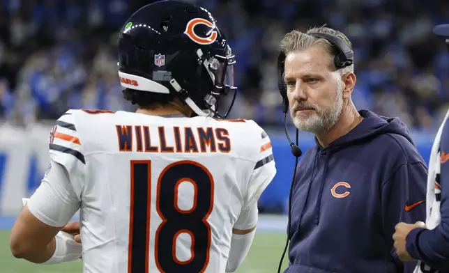 Chicago Bears quarterback Caleb Williams (18) talks with head coach Matt Eberflus during the second half of an NFL football game in Detroit, Thursday, Nov. 28, 2024. (AP Photo/Duane Burleson)