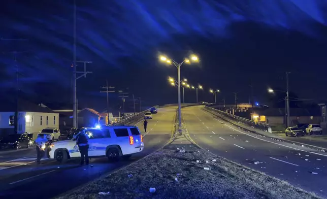 New Orleans Police block the Almonaster Avenue Bridge after a deadly shooting during a second line celebration in New Orleans, Sunday Nov. 17, 2024. (David Grunfeld/The Times-Picayune/The New Orleans Advocate via AP)