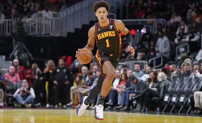 Atlanta Hawks forward Jalen Johnson (1) dribbles the ball down court during the first half of an Emirates NBA Cup basketball game against the Washington Wizards, Friday, Nov. 15, 2024, in Atlanta. (AP Photo/Jason Allen)