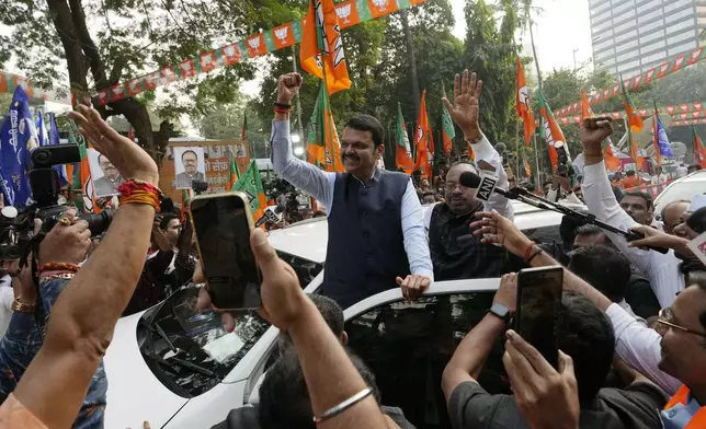 Deputy Chief Minister of Maharashtra, Devendra Fadnavis, center, raises a fist at the Bhartiya Janata Party office in Mumbai, India, Saturday, Nov 23, 2024.(AP Photo/Rajanish Kakade)