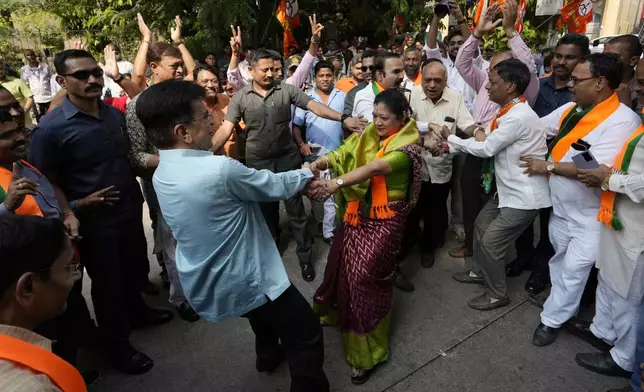 Bhartiya Janata Party workers celebrates after leading in Maharashtra state assembly elections outside party office in Mumbai, India, Saturday, Nov 23, 2024.(AP Photo/Rajanish Kakade)