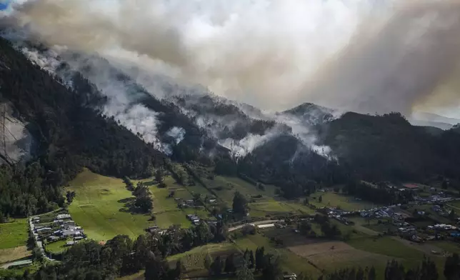 FILE - Smoke rises from a fire burning on the slopes of the mountains surrounding Nemocon, north of Bogota, Colombia, Jan. 23, 2024. (AP Photo/Ivan Valencia, File)