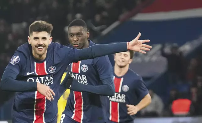 PSG's Lucas Beraldo celebrates after scoring during the French League One soccer match between Paris Saint-Germain and Toulouse at the Parc des Princes stadium in Paris, France, Sunday, Nov. 22, 2024. (AP Photo/Michel Euler)