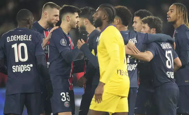 PSG players celebrate after a goal during the French League One soccer match between Paris Saint-Germain and Toulouse at the Parc des Princes stadium in Paris, France, Sunday, Nov. 22, 2024. (AP Photo/Michel Euler)