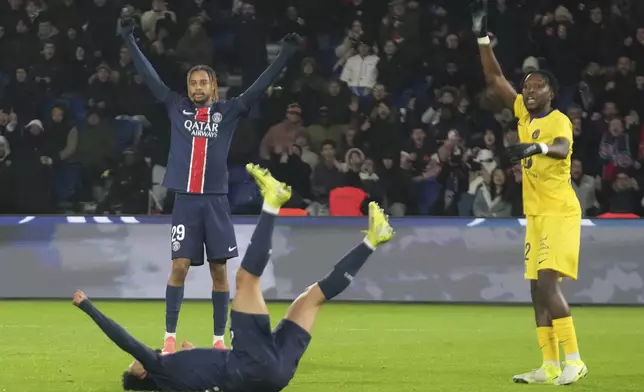 PSG's Warren Zaire-Emery, on the ground, celebrates after scoring during the French League One soccer match between Paris Saint-Germain and Toulouse at the Parc des Princes stadium in Paris, France, Sunday, Nov. 22, 2024. (AP Photo/Michel Euler)