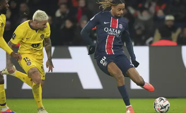 PSG's Bradley Barcola in action sin front of Toulouse's Aron Donnum during the French League One soccer match between Paris Saint-Germain and Toulouse at the Parc des Princes stadium in Paris, France, Sunday, Nov. 22, 2024. (AP Photo/Michel Euler)