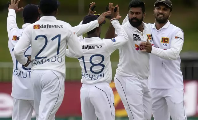 Sri Lanka's Lahiru Kumara, second from right, celebrates with teammates after bowling South Africa's David Bedingham 4 runs during day one of the first Test cricket match between South Africa and Sri Lanka, at Kingsmead stadium in Durban, South Africa, Wednesday, Nov. 27, 2024. (AP Photo/Themba Hadebe)