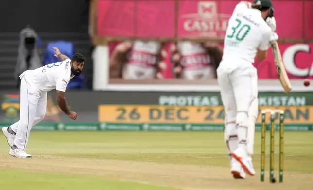 Sri Lanka's Lahiru Kumara, left, bowls against South Africa's Tristan Stubbs during day one of the first Test cricket match between South Africa and Sri Lanka at Kingsmead stadium in Durban, South Africa, Wednesday, Nov. 27, 2024. (AP Photo/Themba Hadebe)