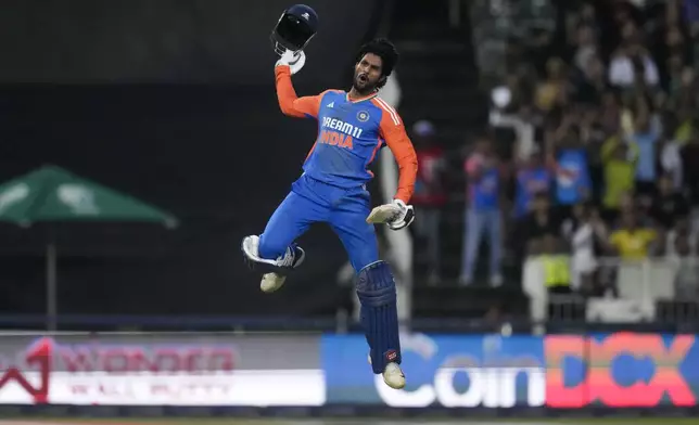 India's Tilak Varma celebrates after scoring a century during the fourth T20 cricket match between South Africa and India at the Wanderers Stadium in Johannesburg, South Africa, Friday, Nov. 15, 2024. (AP Photo/Themba Hadebe)