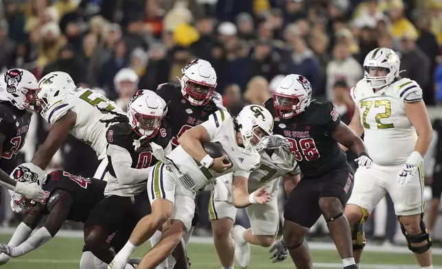 Georgia Tech quarterback Aaron Philo (12) runs the ball during the first half of an NCAA college football game against North Carolina State, Thursday, Nov. 21, 2024, in Atlanta. (AP Photo/Brynn Anderson)