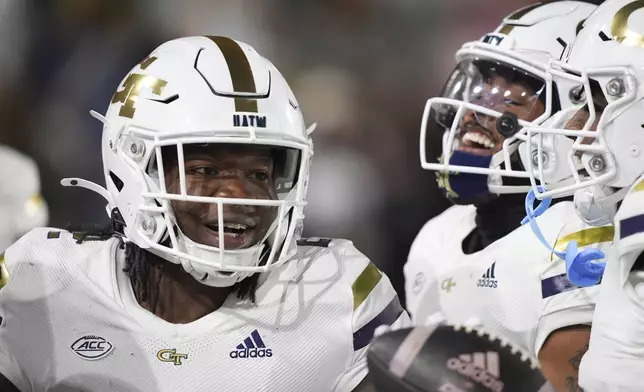 Georgia Tech linebacker E.J. Lightsey (2) celebrates a touchdown after an interception during the first half of an NCAA college football game against North Carolina State, Thursday, Nov. 21, 2024, in Atlanta. (AP Photo/Brynn Anderson)