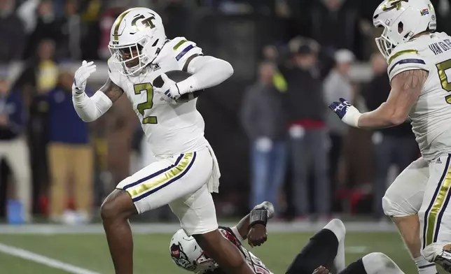 Georgia Tech linebacker E.J. Lightsey (2) runs in a touchdown after an interception during the first half of an NCAA college football game North Carolina State, Thursday, Nov. 21, 2024, in Atlanta. (AP Photo/Brynn Anderson)