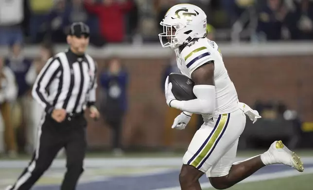 Georgia Tech linebacker E.J. Lightsey (2) runs in a touchdown after an interception during the first half of an NCAA college football game North Carolina State, Thursday, Nov. 21, 2024, in Atlanta. (AP Photo/Brynn Anderson)