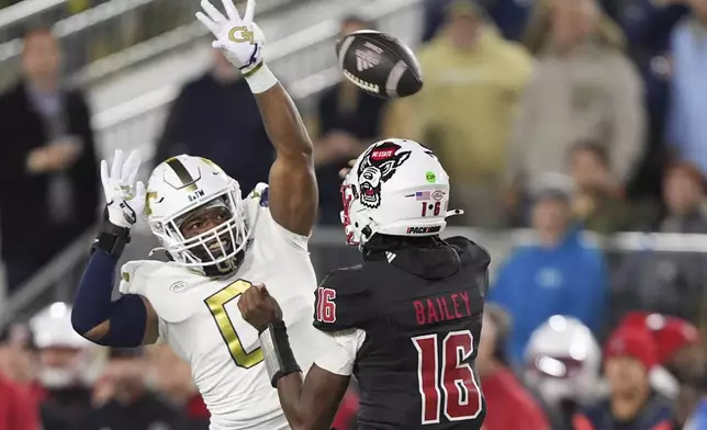 Georgia Tech linebacker Trenilyas Tatum (0) blocks a pass thrown by North Carolina State quarterback CJ Bailey (16) during the first half of an NCAA college football game, Thursday, Nov. 21, 2024, in Atlanta. (AP Photo/Brynn Anderson)