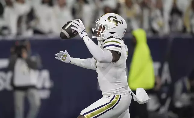 Georgia Tech linebacker E.J. Lightsey (2) runs in a touchdown celebrating after an interception during the first half of an NCAA college football game North Carolina State, Thursday, Nov. 21, 2024, in Atlanta. (AP Photo/Brynn Anderson)