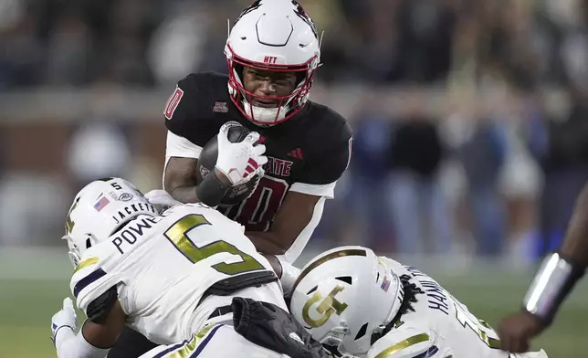 North Carolina State wide receiver Kevin Concepcion (10) runs the ball during the first half of an NCAA college football game, Thursday, Nov. 21, 2024, in Atlanta. (AP Photo/Brynn Anderson)