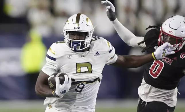 Georgia Tech wide receiver Avery Boyd (9) runs the ball against North Carolina State linebacker Sean Brown (0) during the first half of an NCAA college football game, Thursday, Nov. 21, 2024, in Atlanta. (AP Photo/Brynn Anderson)