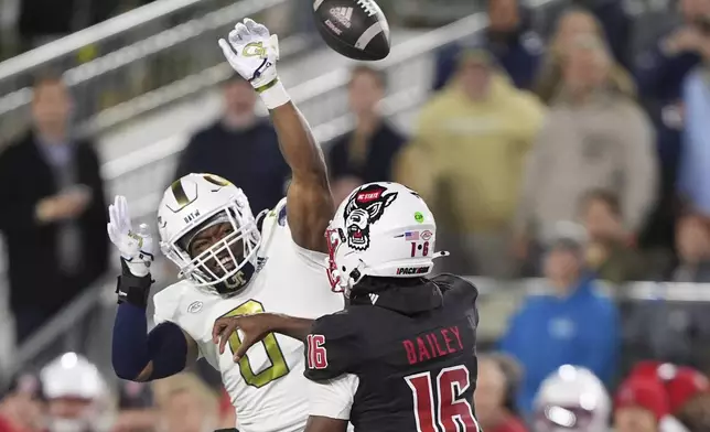 Georgia Tech linebacker Trenilyas Tatum (0) blocks a pass thrown by North Carolina State quarterback CJ Bailey (16) during the first half of an NCAA college football game, Thursday, Nov. 21, 2024, in Atlanta. (AP Photo/Brynn Anderson)