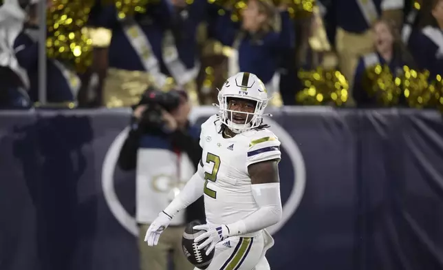 Georgia Tech linebacker E.J. Lightsey (2) celebrates a touchdown after an interception during the first half of an NCAA college football game against North Carolina State, Thursday, Nov. 21, 2024, in Atlanta. (AP Photo/Brynn Anderson)