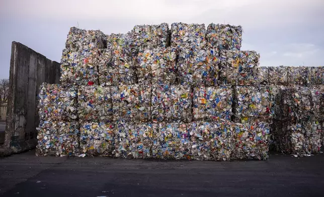 Plastic garbage bales stand at the courtyard of the Interzero plastic sorting facility in Berlin, Germany, Wednesday, Nov. 27, 2024. (AP Photo/Markus Schreiber)