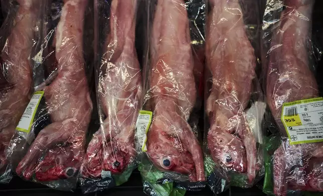 Rabbits wrapped in plastic bags are displayed for sale at a market in downtown Barcelona, Spain, Wednesday, Nov. 27, 2024. (AP Photo/Emilio Morenatti)