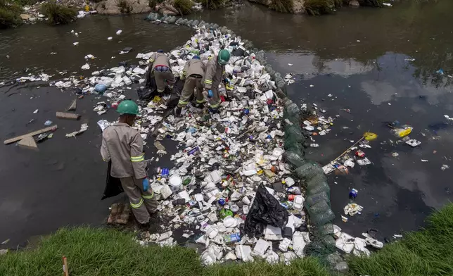 Alexandra Water Warriors volunteers cleanup the Juksei river in the heart of Alexandra township from plastic pollution in Johannesburg, South Africa, Wednesday, Nov. 27, 2024. (AP Photo/Jerome Delay)