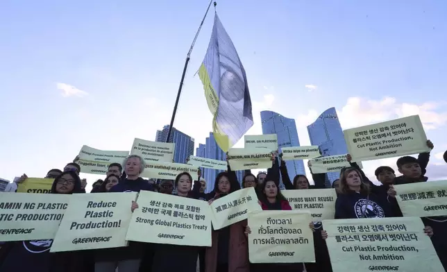 Activists from Greenpeace hold banners ahead of the opening ceremony of the fifth session of the Intergovernmental Negotiating Committee on Plastic Pollution in Busan, South Korea, Monday, Nov. 25, 2024. (Kang Sun-bae/Yonhap via AP)