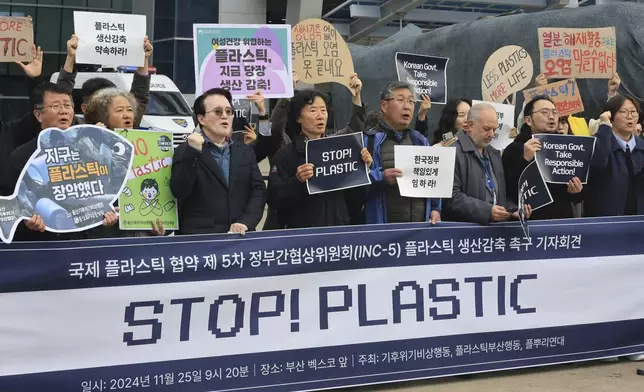 Environment activists shout slogans during the press conference outside of the venue for the fifth session of the Intergovernmental Negotiating Committee on Plastic Pollution in Busan, South Korea, Monday, Nov. 25, 2024. (Cha Keun-ho/Yonhap via AP)