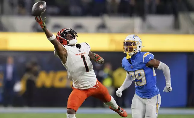 Cincinnati Bengals wide receiver Ja'Marr Chase (1) reaches but cannot make a catch in front of Los Angeles Chargers cornerback Tarheeb Still (29) during the second half of an NFL football game Sunday, Nov. 17, 2024, in Inglewood, Calif. (AP Photo/Eric Thayer)