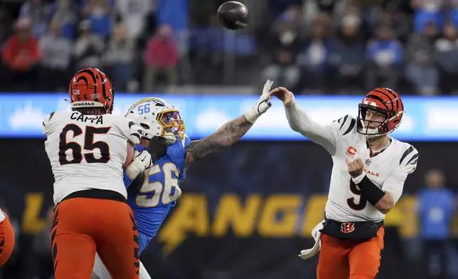 Cincinnati Bengals quarterback Joe Burrow (9) throws a pass under pressure from Los Angeles Chargers defensive end Morgan Fox (56) during the second half of an NFL football game Sunday, Nov. 17, 2024, in Inglewood, Calif. (AP Photo/Eric Thayer)