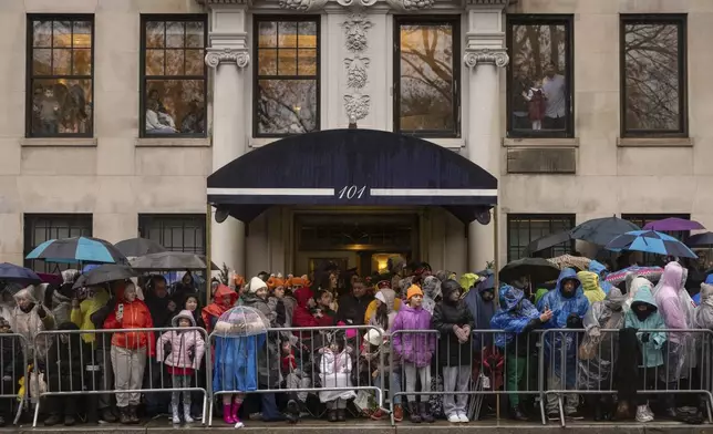 Spectators watch the Macy's Thanksgiving Day Parade, Thursday, Nov. 28, 2024, in New York. (AP Photo/Yuki Iwamura)