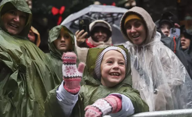 Chandler Butler, 6, waves at floats during the Macy's Thanksgiving Day Parade, Thursday, Nov. 28, 2024, in New York. (AP Photo/Heather Khalifa)