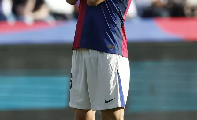 Barcelona's Gavi reacts after missing a chance to score a goal against Las Palmas during a Spanish La Liga soccer match at the Lluis Companys Olympic Stadium in Barcelona, Spain, Saturday Nov. 30, 2024. (AP Photo/Joan Monfort)
