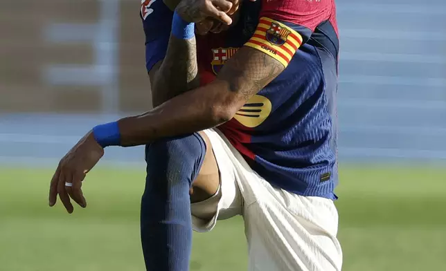 Barcelona's Raphinha reacts after missing a chance to score a goal against Las Palmas during a Spanish La Liga soccer match at the Lluis Companys Olympic Stadium in Barcelona, Spain, Saturday Nov. 30, 2024. (AP Photo/Joan Monfort)