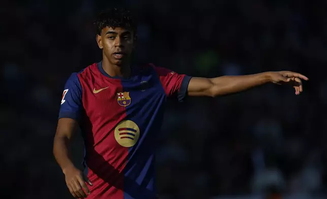 Barcelona's Lamine Yamal gestures during a Spanish La Liga soccer match against Las Palmas at the Lluis Companys Olympic Stadium in Barcelona, Spain, Saturday Nov. 30, 2024. (AP Photo/Joan Monfort)