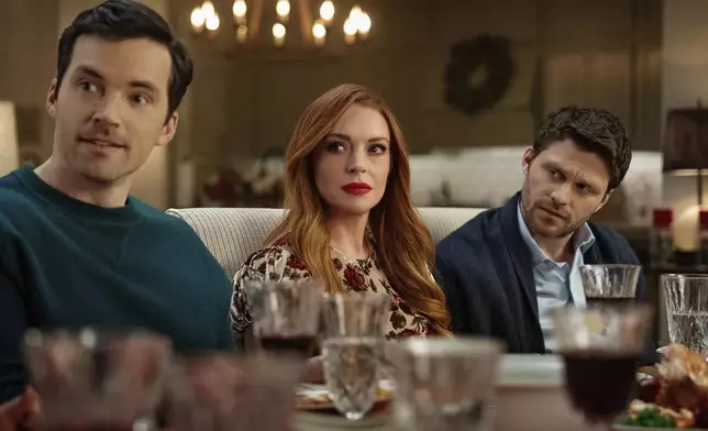 This image released by Netflix shows Ian Harding, from left, Lindsay Lohan and Jon Rudnitsky in a scene from "Our Little Secret." (Bob Mahoney/Netflix via AP)