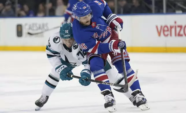 New York Rangers' Vincent Trocheck, right, and San Jose Sharks' William Eklund, left, compete for the puck during the first period of an NHL hockey game Thursday, Nov. 14, 2024, in New York. (AP Photo/Seth Wenig)