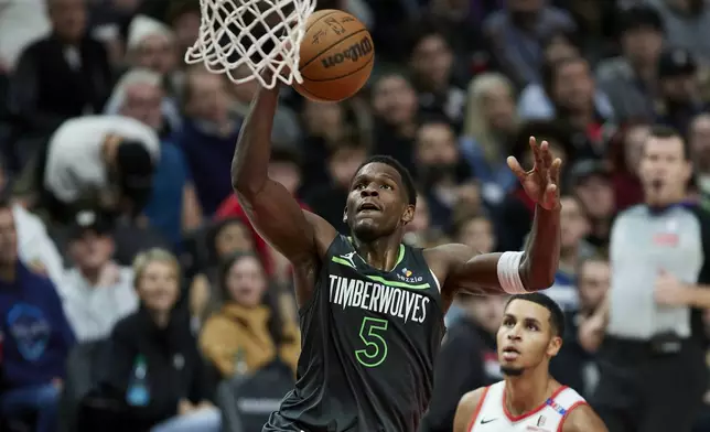 Minnesota Timberwolves guard Anthony Edwards (5) shoots over Portland Trail Blazers forward Kris Murray during the second half of an NBA basketball game in Portland, Ore., Wednesday, Nov. 13, 2024. (AP Photo/Craig Mitchelldyer)