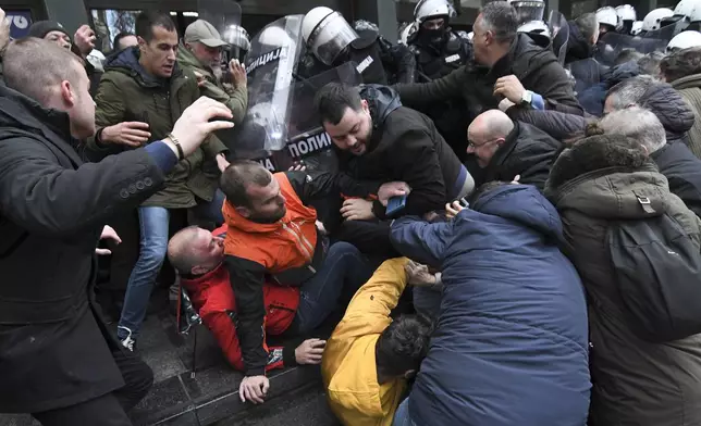 Serbian police officers scuffled with opposition protesters demanding arrests over a deadly roof collapse at a railway station in Novi Sad, Serbia, Thursday, Nov. 21, 2024. (AP Photo)