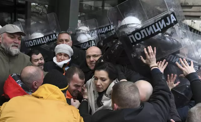 Serbian police officers scuffled with opposition protesters demanding arrests over a deadly roof collapse at a railway station in Novi Sad, Serbia, Thursday, Nov. 21, 2024. (AP Photo)