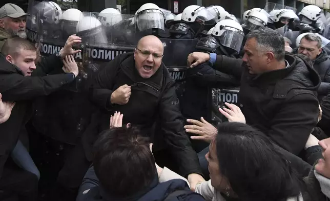 Serbian police officers scuffled with opposition protesters demanding arrests over a deadly roof collapse at a railway station in Novi Sad, Serbia, Thursday, Nov. 21, 2024. (AP Photo)