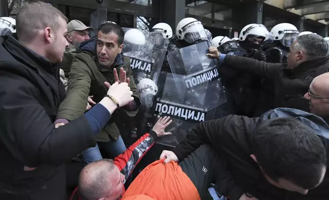 Serbian police officers scuffled with opposition protesters demanding arrests over a deadly roof collapse at a railway station in Novi Sad, Serbia, Thursday, Nov. 21, 2024. (AP Photo)