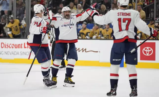 Washington Capitals left wing Alex Ovechkin, center, celebrates after scoring against the Vegas Golden Knights during the first period of an NHL hockey game Sunday, Nov. 17, 2024, in Las Vegas. (AP Photo/John Locher)