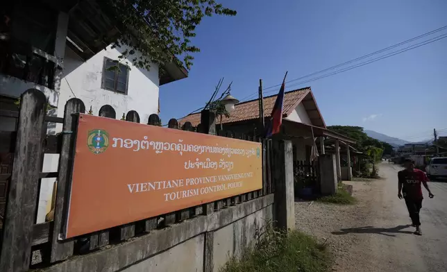 A man walks past the tourism control police station in Vang Vieng, Laos, Friday, Nov. 22, 2024. (AP Photo/Anupam Nath)